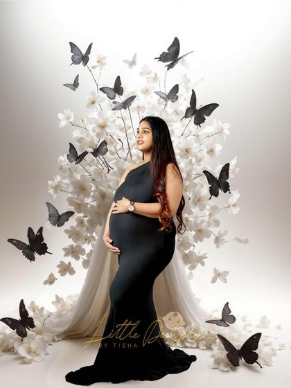 A beautiful composition with a mom-to-be in a black gown surrounded by butterflies. This is a unique and artistic concept we can create in the studio.