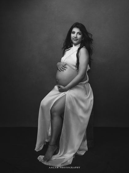 The elegance of the white silk drape is beautifully captured in this monochrome portrait, focusing on texture and form.