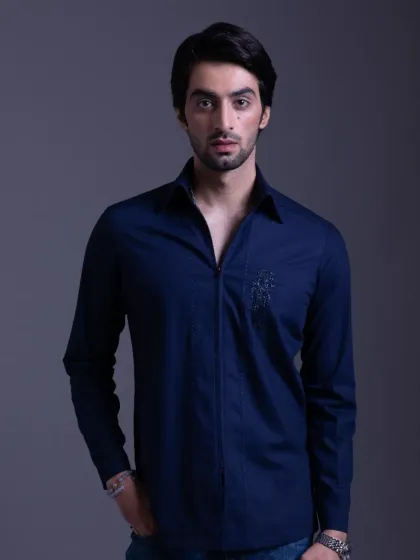 A deep navy blue shirt with a zip-front and subtle embroidery. This piece is designed for bold moves, tailored to the finest detail.