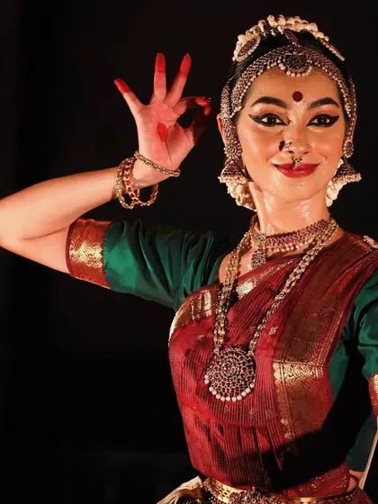 A still from a performance, capturing a specific mudra and expression. The hands, eyes, and face all work together to tell the story.