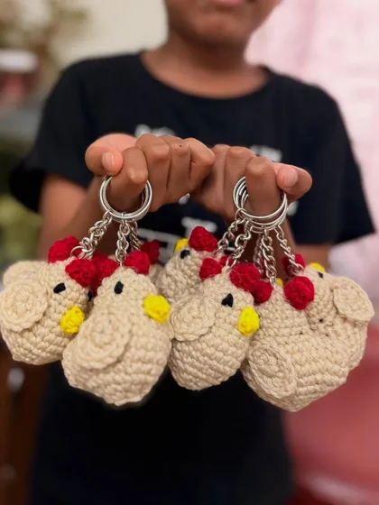 A handful of my quirky crochet chicken keychains. These are a fun and playful accessory that always gets noticed.
