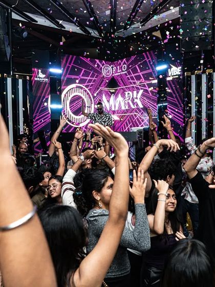 The crowd's hands are up as confetti falls at Flo.