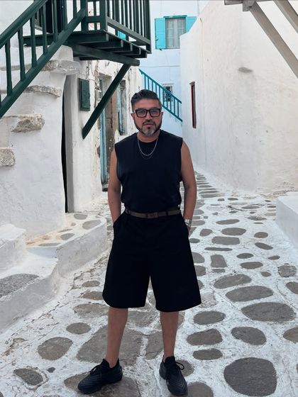 Another shot from the streets of Mykonos, hands in pockets, embodying the relaxed and cool vibe of the island.