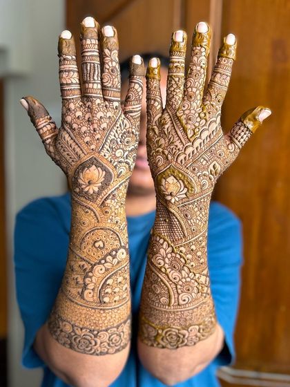 A playful pose showing off this intricate Indian design, which features beautiful lotus motifs on the back of the hands.