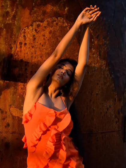A graceful, reaching pose that creates beautiful lines. The warm, directional light adds to the drama of the shot.