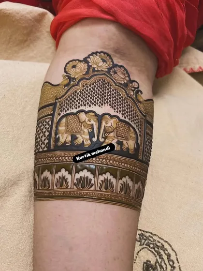 A detailed close-up of an arm band showing two majestic elephants, a classic symbol of royalty and strength in bridal mehandi.