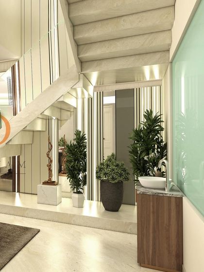 A view showing the staircase and a small wash basin area neatly integrated into the living space, highlighting smart space planning.