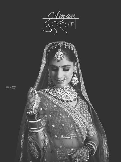 A classic black and white bridal portrait with a beautiful Hindi calligraphy overlay. The bride, Aman, looks elegant and timeless.