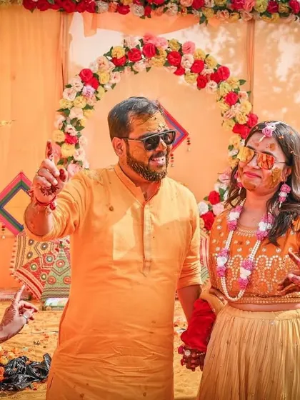 It's all about fun and games. The couple shares a lighthearted moment amidst the colorful decor, showcasing the relaxed and celebratory atmosphere we help create.