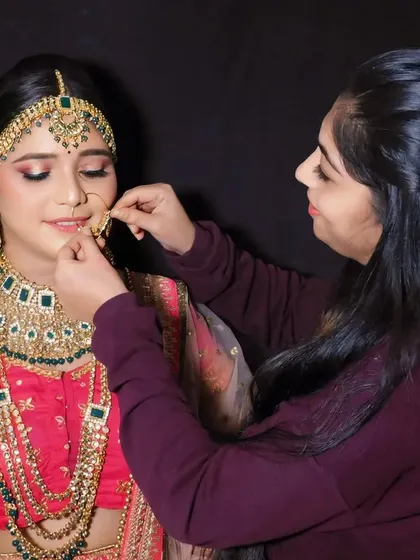 Here I am, making the final adjustments to the bride's nose ring. I am personally involved in every step to ensure absolute perfection.