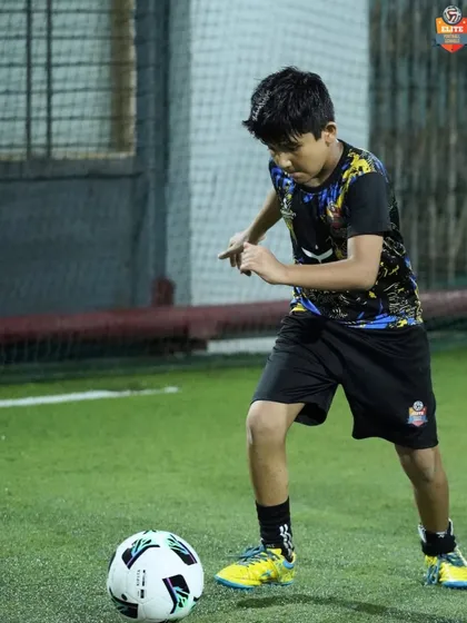 With intense focus, a young player prepares to make his next move. Each training session is an opportunity to improve and grow.