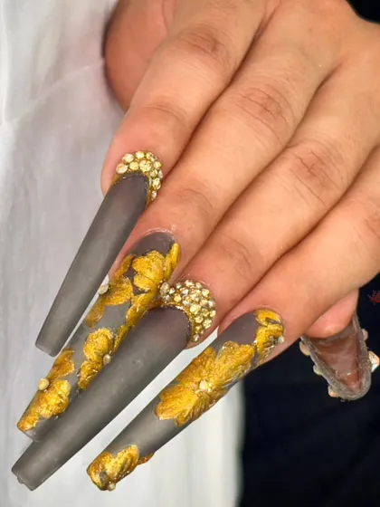 This shot highlights the intricate gold leaf pattern and the sparkling crystal accents against the smoky grey matte base.