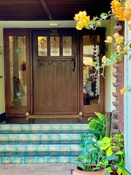 The entrance to the Roopa Hariprasad Residence sets a warm and inviting tone with a custom-crafted wooden door and patterned tile steps. We believe a home's entrance should be a statement of the style and character found within.