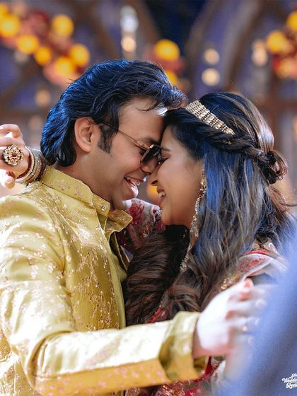 A close-up of the couple dancing, their faces close together, capturing the romance of the Sangeet night.