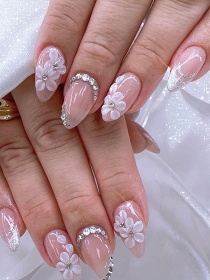 This is 3D floral art at its most elegant. I sculpted these delicate white flowers and paired them with stunning crystal crescent moons on a sheer nude base for a truly showstopping bridal manicure.