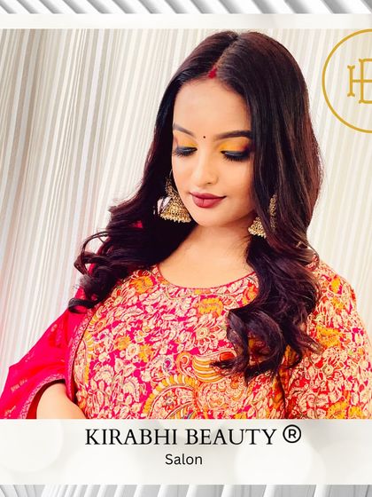 A warm, festive look with golden-orange eyeshadow and a deep red lip. This makeup is perfect for traditional Indian festivals and weddings.