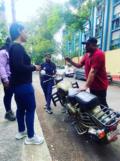 A group of women learning the basics of motorcycle operation. Our training is designed for absolute beginners, with no prior experience necessary.