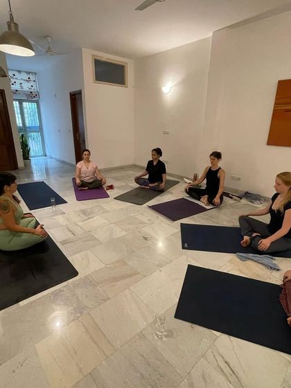 A group of students listening intently during a breathwork workshop. These sessions are not just about breathing but also about learning and sharing in a community setting.