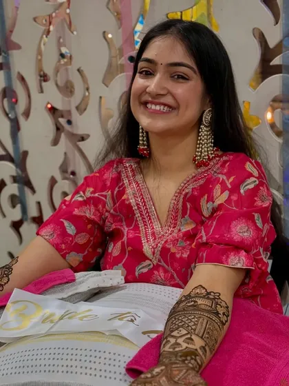 A happy shot from my mehendi night. The simple styling with bold earrings and loose hair was intentional, keeping the focus on the intricate henna and the joyous occasion.