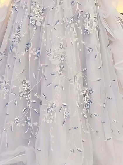 A close-up of the beautiful fabric and embroidery on this grey ruffle gown-style lehenga. The details are what make our rental outfits special.