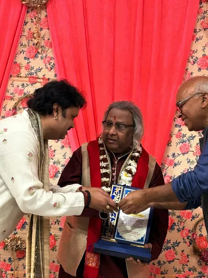 A moment of felicitation, where I am honoring a guest artist at our 'Raghunathanjali' event. We believe in showing respect and gratitude to all artists who share their gift with us.