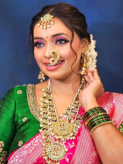 This shot captures the joy of the bride, with her makeup looking flawless and radiant.