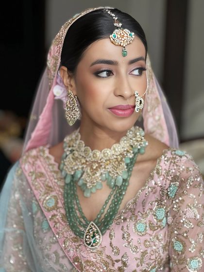 This portrait showcases the unique color combination of the bride's attire. The makeup was designed to tie in the pink and mint green elements for a cohesive and beautiful look.