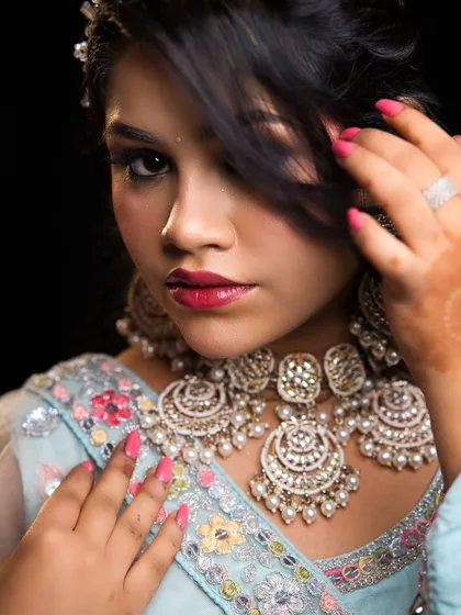 A soft, romantic look in a pastel blue outfit. This showcases our students' ability to create subtle and elegant makeup for pre-wedding functions.