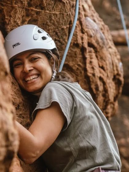 The pure joy of being on the rock. This climber's smile says it all. Our roped climbing sessions are about embracing the challenge and having fun.