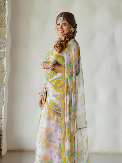 A beautiful portrait of a bride in a floral saree, complemented by our floral accessories.