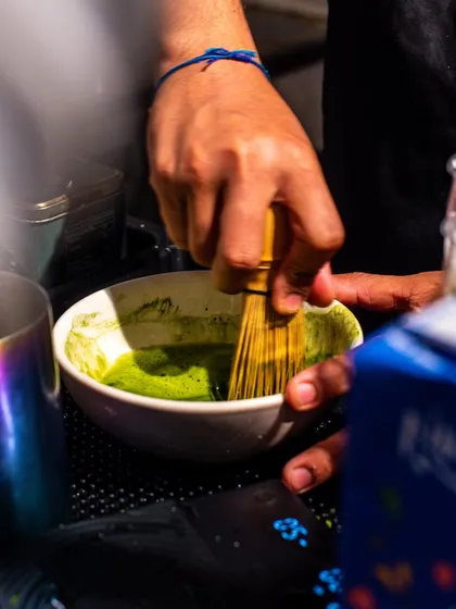 A shot of a barista at Bokka Coffee whisking matcha, showing the traditional and authentic preparation method.