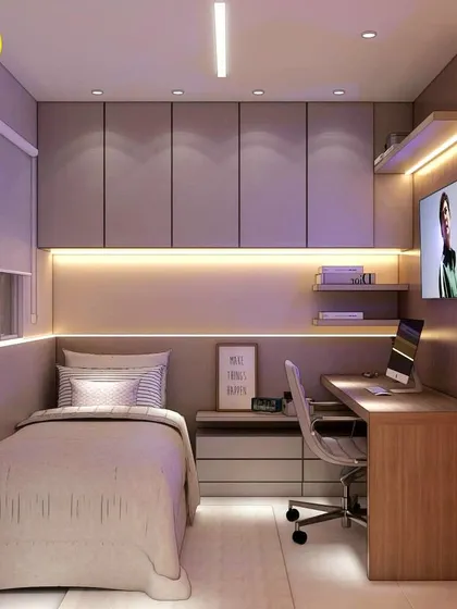 A compact and cozy bedroom, perfect for a student. The design includes a bed, a study desk with a computer, and plenty of overhead storage cabinets.