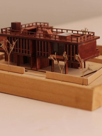 A side view of the Holiday Home model, showcasing the intricate details of the window mullions and railings. We believe in the power of craft, both in our models and our buildings.