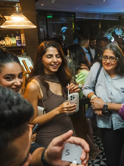 A guest reacts with a smile as I correctly guess the information she was thinking of during the Hendrick's Gin event.