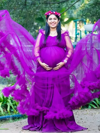 Like a beautiful butterfly. The sleeves of this purple gown create a wing-like effect, making for a truly magical maternity photo.