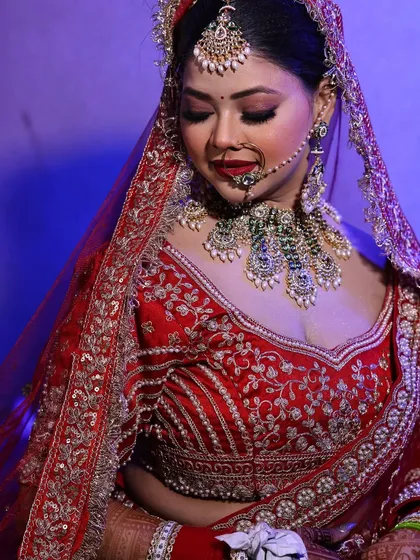A close-up of this bride's beautiful makeup. The focus is on the bold red lip and flawless skin, a classic combination.