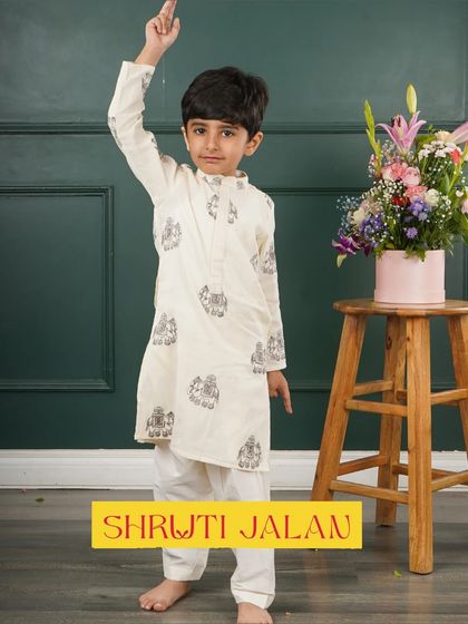 This little boy is ready to celebrate in his off-white printed kurta. The subtle design and comfortable fit make it a great choice for long events.