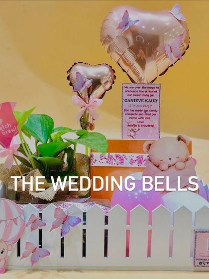 A single birth announcement hamper for a baby girl. The white picket fence basket and pink accents create a sweet and charming look.