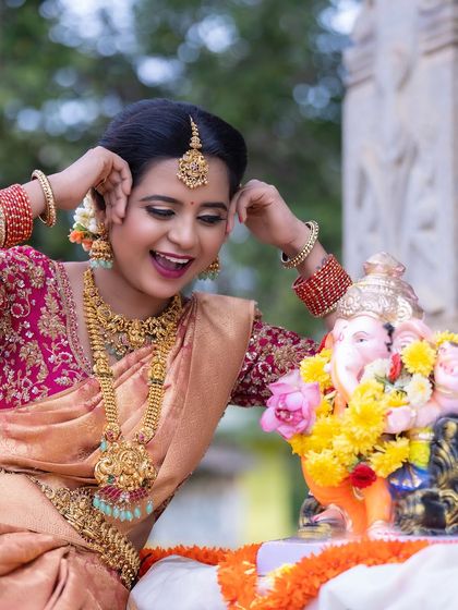 A joyful moment captured during a festive shoot. The model wears a complete set of our rental temple jewellery, showing its versatility for various celebrations.