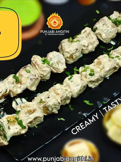 Behold, the Malai Chaap Tikka. It's creamy, it's dreamy, and it melts in your mouth. I marinate it in a special blend of mild spices and cream before grilling it to perfection in the tandoor. It’s a guaranteed crowd-pleaser.