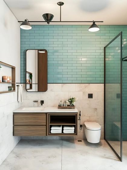A fresh and modern bathroom design using a combination of aqua subway tiles and white marble. The floating wooden vanity and glass shower partition keep the space feeling open and bright.