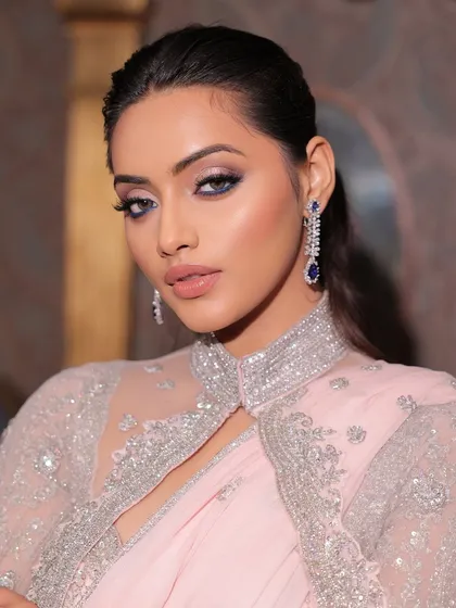 A powerful and chic pose in a modern saree. The makeup is sharp and sophisticated, designed to make a statement at any high-end event.