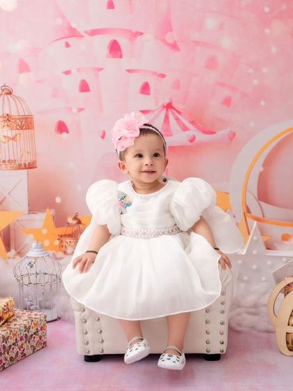 A full view of the enchanting "One" birthday setup, with a fairytale carriage, stars, and a beautifully dressed birthday girl.