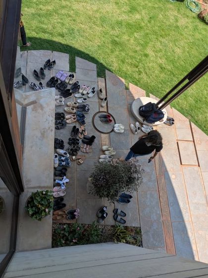 The collection of shoes at the entrance is always a beautiful sign of a well-loved and inhabited space. It speaks to a sense of community and shared experience, a testament to the home's welcoming spirit.