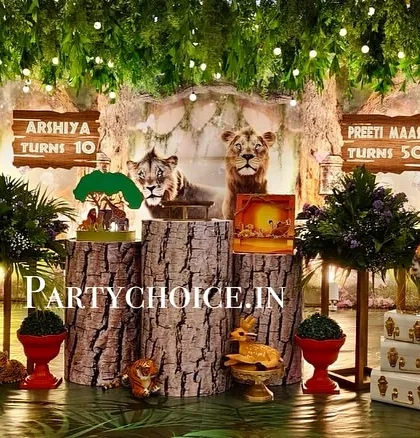 We created an enchanted forest with this 3D jungle theme decoration. The setup includes realistic, life-sized props of a deer and tiger, tree-stump pedestals for the cake, and a ceiling covered in hanging greenery and lights to make guests feel like they've stepped into a different world.
