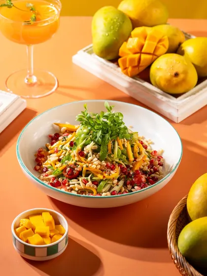 A healthy and vibrant mango salad, perfect for a summer menu. The colors are fresh and appealing.