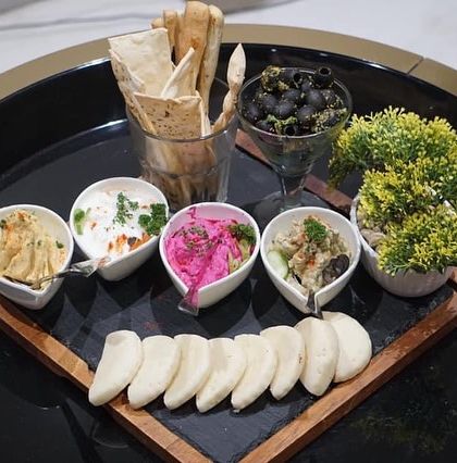 A beautiful Mezze platter served at a Lohri celebration. It included a variety of dips, pita bread, and olives, offering a modern touch to the traditional festival.