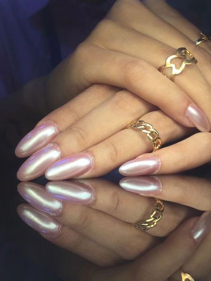 A stunning set of long almond nails with a pearlescent pink chrome finish.