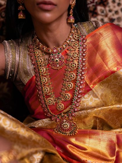 Another detailed shot of the bridal jewelry against the rich texture of the silk saree, showcasing a look of pure opulence.