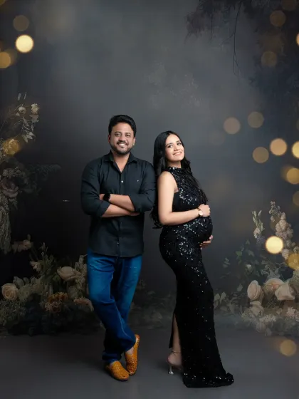 A full-length portrait of the happy couple. Dressed in elegant black, they stand together in our magical, softly lit floral set.